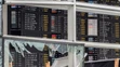Pohľad cez rozbité okno na tabuľu odletov po teroristickom výbuchu na letisku Zaventem 23. marca.