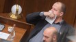 Peter Krupa si prekrýva tvár papierovou vreckovkou a dole Andrej Medvecký (obaja ĽSNS).