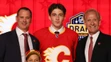 Samuel Honzek pózuje v drese Calgary na NHL drafte 2023.
