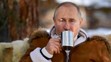 Ruský prezident Vladimir Putin pije zo šálky v rámci prestávky počas víkendovej návštevy tajgy na Sibíri 21. marca 2021..jpg