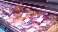 Mačka sa kŕmila morskými rybami vo výklade obchodu