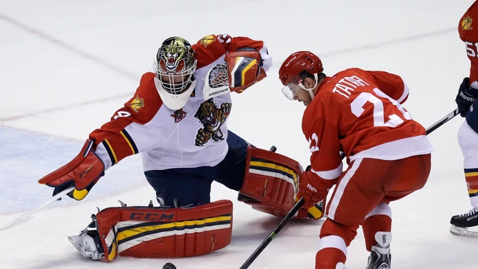 Brankár Floridy Panthers Tim Thomas (vľavo) odráža strelu Slováka Tomáša Tatara z Detroitu Red Wings v zápase hokejovej zámorske