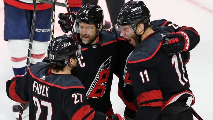 Hokejisti Caroliny Jordan Staal (11), Justin Faulk (27) a Justin Williams (14) sa tešia po strelení gólu.