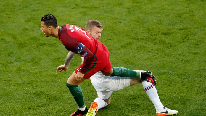 Portugalská superstar Cristiano Ronaldo (vľavo) v súboji s Islanďanom Aronom Gunnarssonom počas duelu na ME vo Francúzsku.