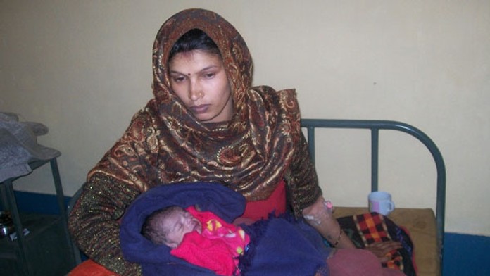 Matka drží v náručí svojho syn,a ktorý sa narodil so vzácnou vadou