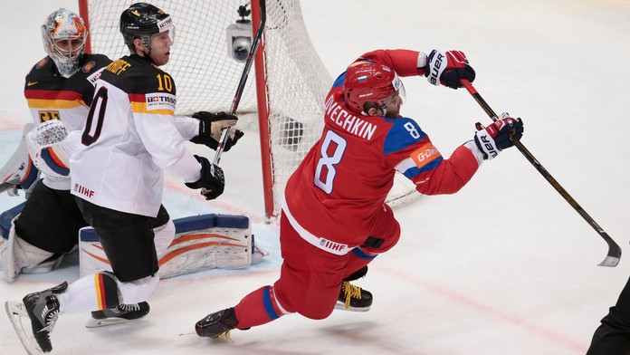 Ruská hviezda Alexander Ovečkin (vpravo) padá v súboji o puk s Nemcom Christianom Ehrhoffom pred nemeckou bránkou v zápase štvrť