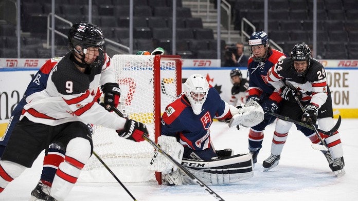 Na snímke hráči  Kanady vľavo Graeme Clarke a vpravo Xavier Parent pred brankárom Slovenska Dávidom Borákom.
