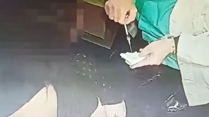 Sestrička vyprázdňuje očkovaciu látku do obväzu.