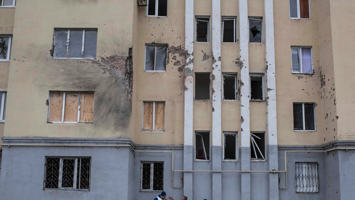 Príslušníci OBSE monitorujú vyšetrovanie pred poškodenou bytovkou po sobotňajšom raketovom útoku v obytnej štvrti vo východoukra