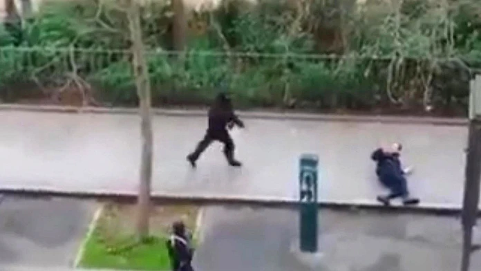 Na snímke, ktorá pochádza z videozáznamu parížskeho obyvateľa dvaja maskovaní útočníci strieľajú na človeka na ulici počas útoku