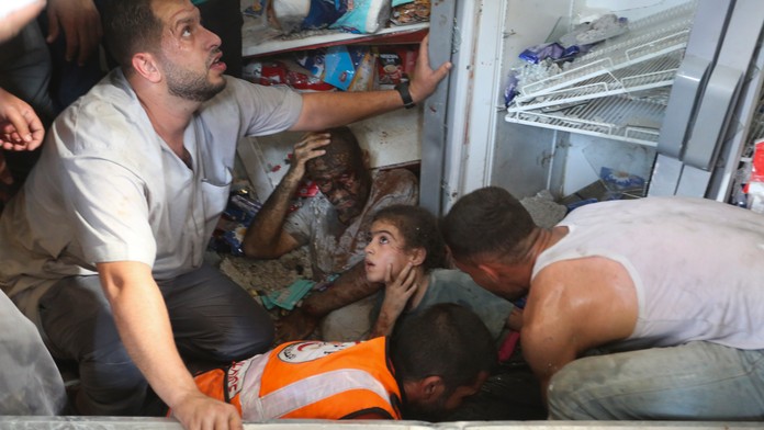 Palestínčania zachraňujú preživších po izraelskom leteckom útoku na pásmo Gazy v meste Rafah.