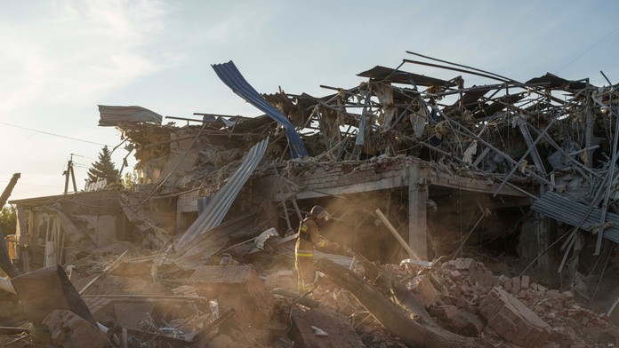 Hasič zbiera úlomky rakety po ruskom útoku na hotel v meste Kramatorsk v Doneckej oblasti na východe Ukrajiny.