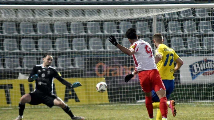 Na snímke uprostred hráč ŠKF Sereď Roko Jureškin strieľa gól brankárovi MFK Zemplín Michalovce Andrijovi Kožucharovi.