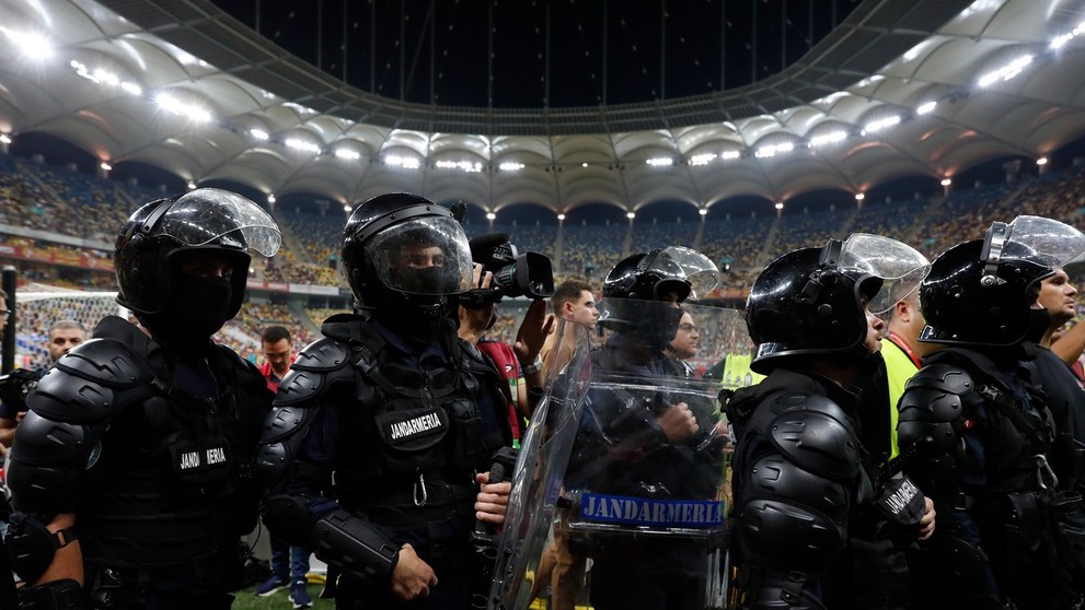 Ťažkoodenci stoja pri tribúne domácich ultras.