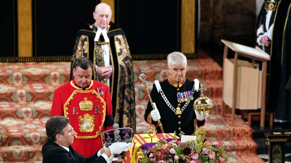 Kráľovský klenotník berie kráľovskú korunu z rakvy s pozostatkami zosnulej britskej kráľovnej Alžbety II.