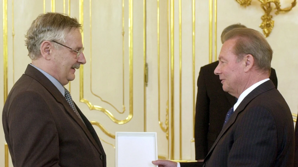 Juraj Slezáček preberá 1. júna 2004  z rúk prezidenta Rudolfa Schustera ocenenie Kríž prezidenta SR II. stupňa.