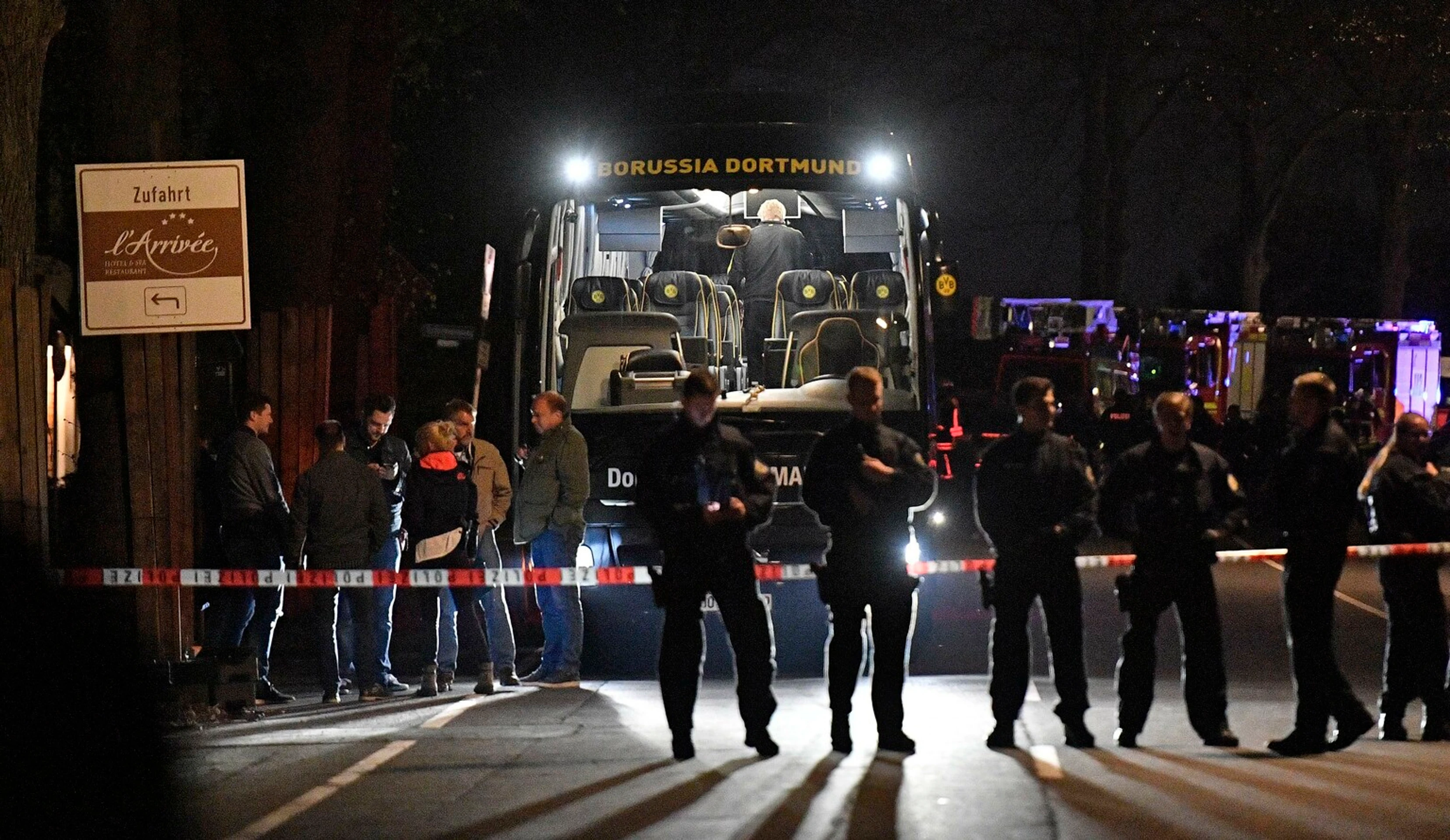 Policajti stoja pred autobusom Borussie Dortmund, pri ktorom vybuchli nálože pred štvrťfinále LM proti Monacu.