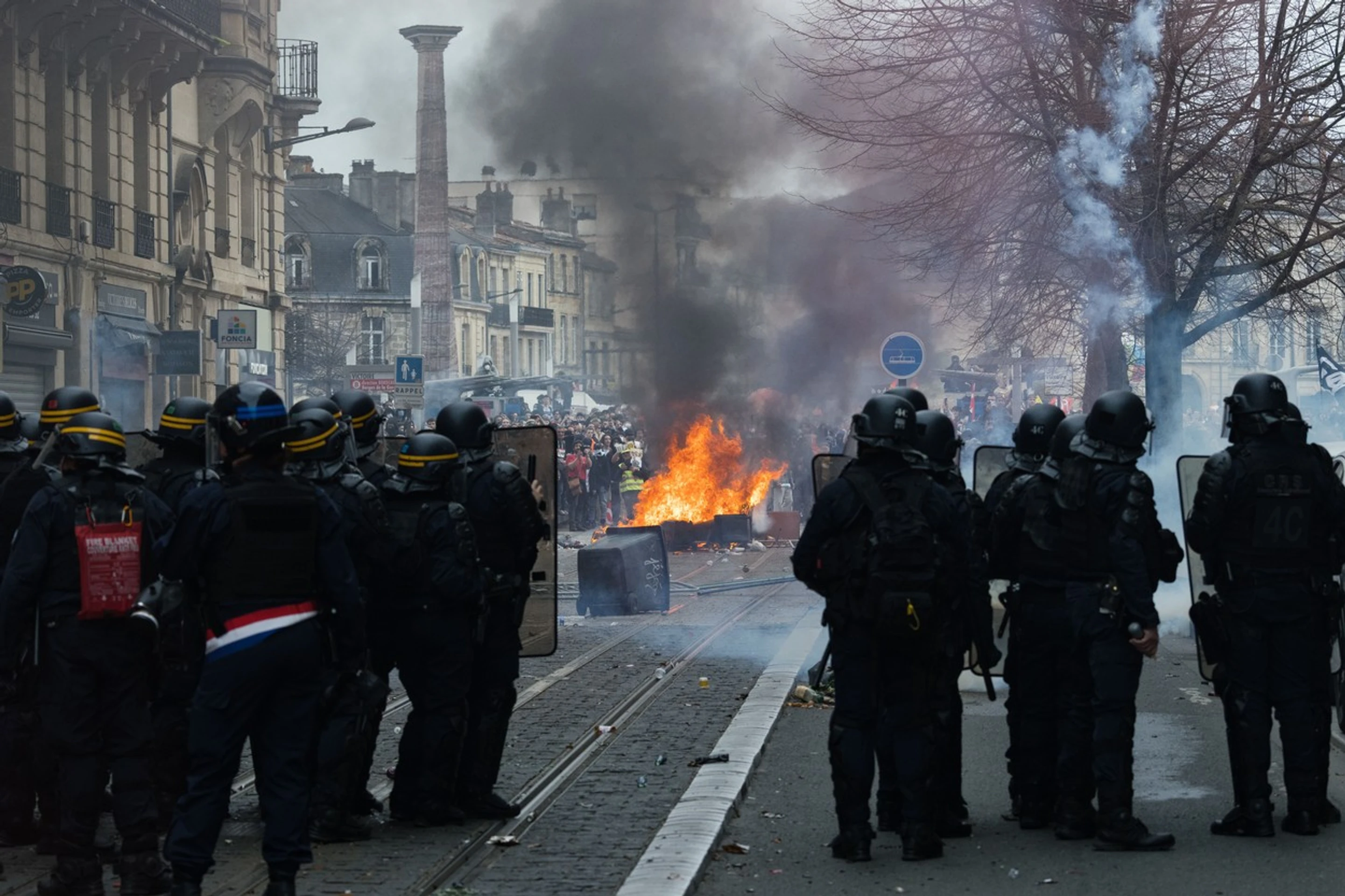 Policajti požívajú slzotvorný plyn proti protestujúcemu davu v Bordeaux.