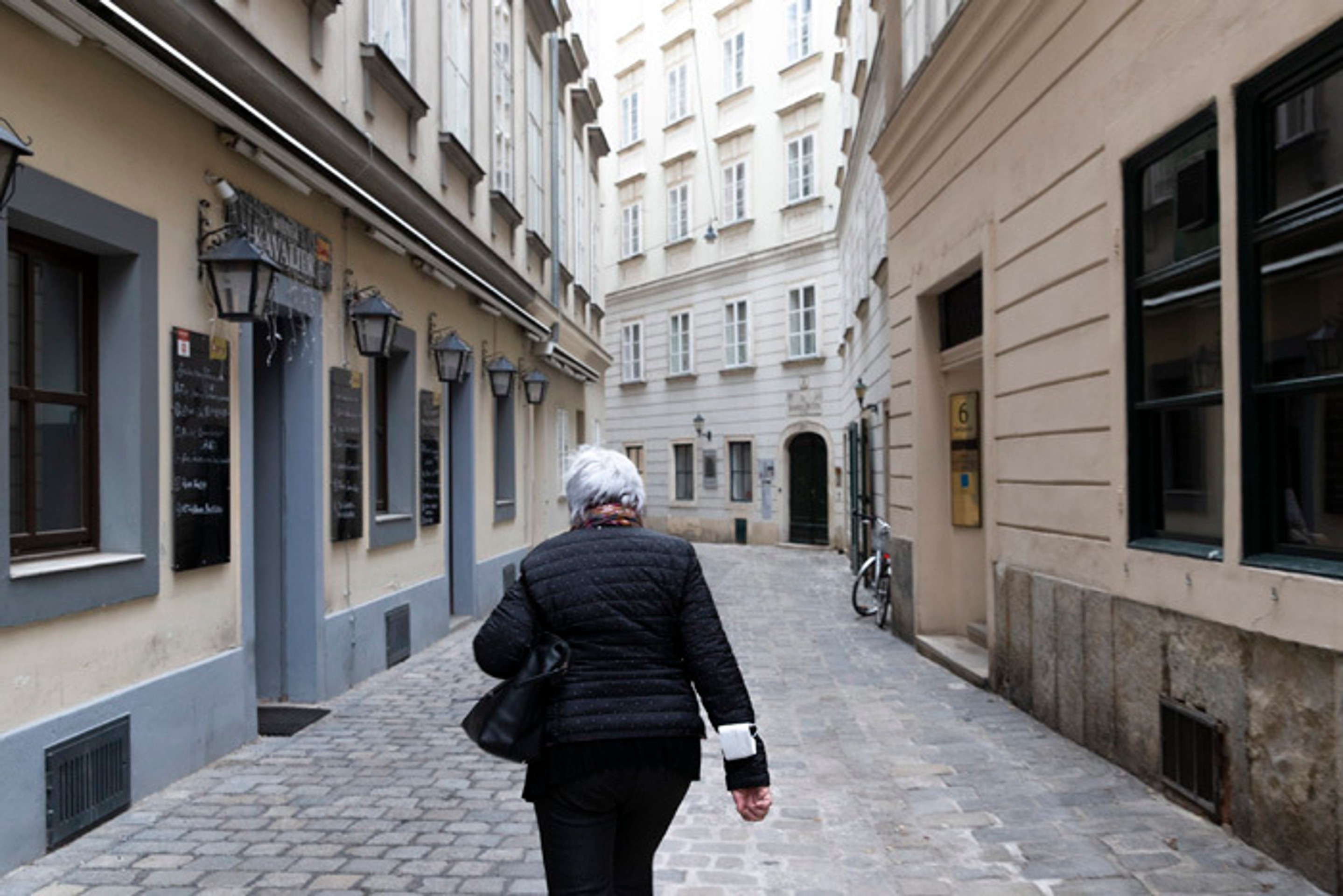  Žena kráča po viedenskej prázdnej ulici počas celoštátneho lockdownu.