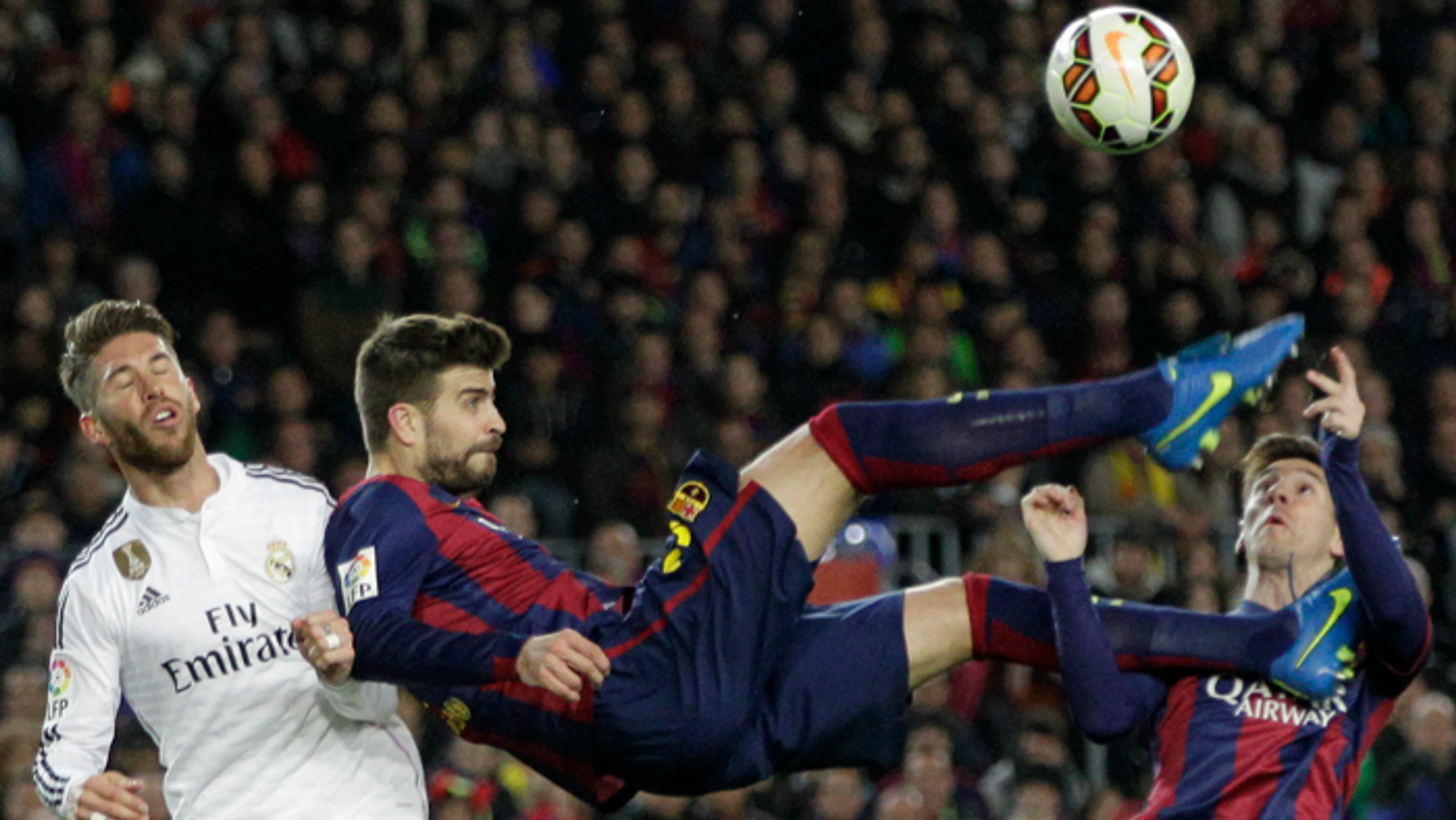 Gerard Pique a Lionel Messi (Barcelon) v akcii so Sergiom Ramosom (Real Madrid) počas  El Clásico.
